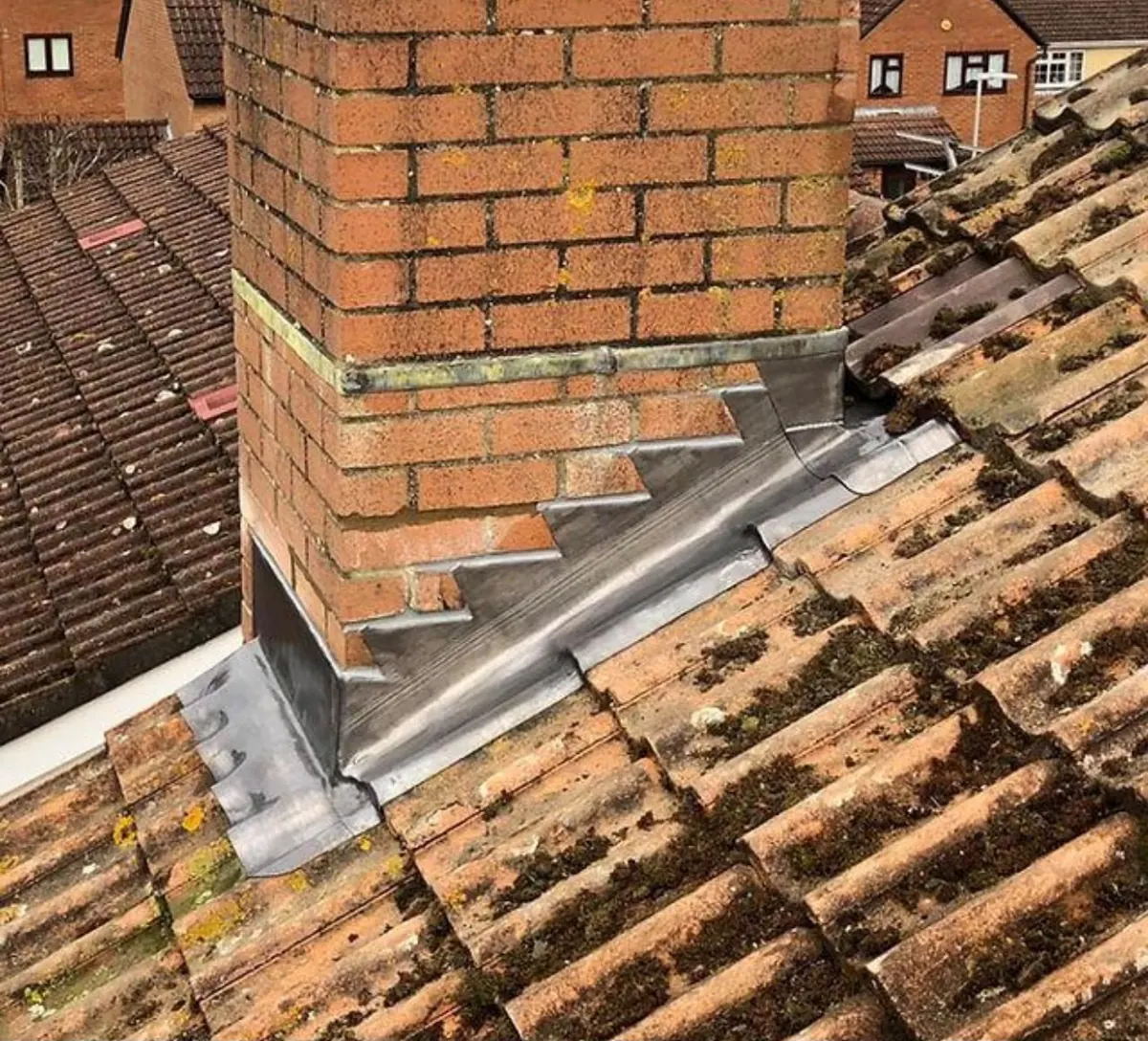 New lead flashing fitted around a brick chimney by Yellowstone Roofing