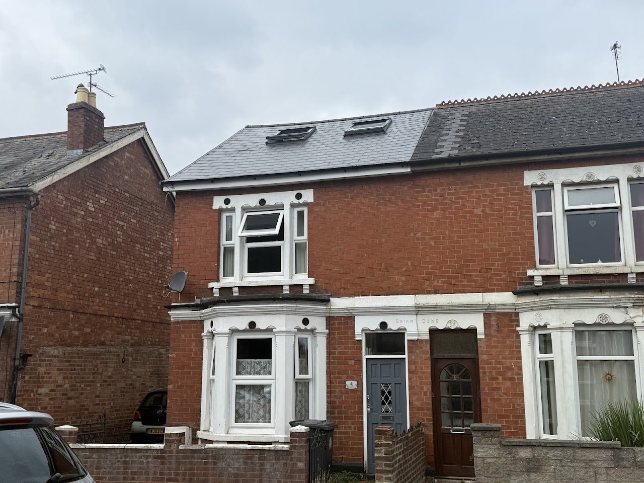 Semi-detached brick house with a new slate roof and two rooflights
