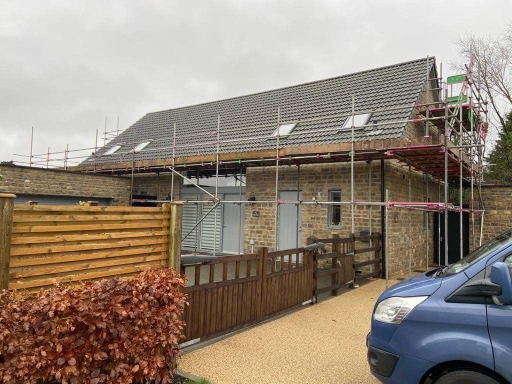 Stone-built house with a new tiled roof, rooflights and a resin driveway