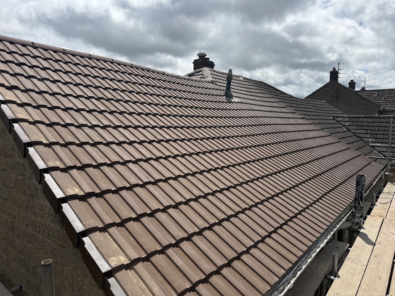 New brown tiled roof with fresh ridge line