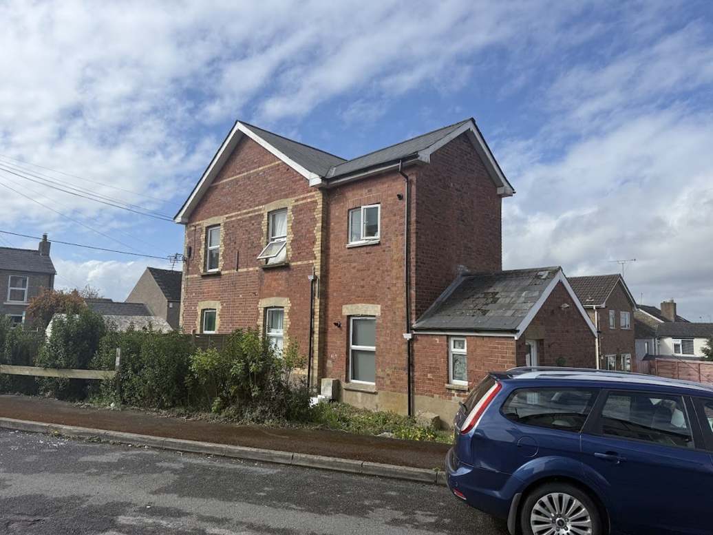 Detached brick house with a new roof