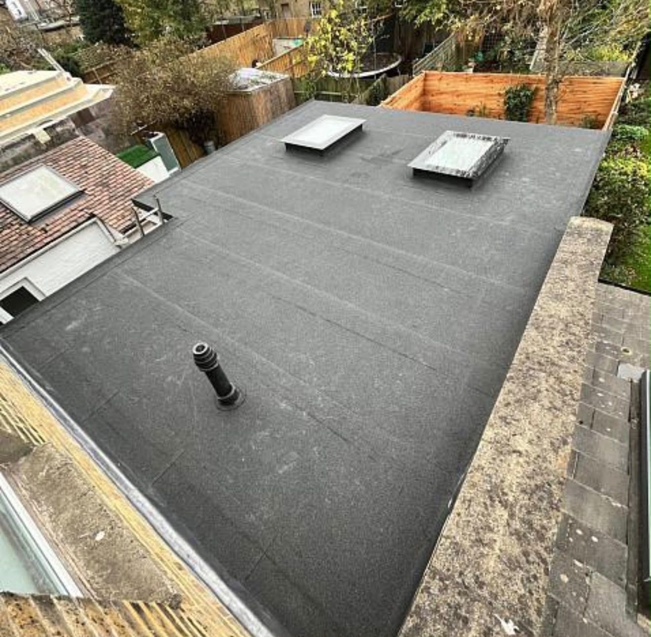 Finished torch-on felt flat roof with two rooflights and a vent pipe