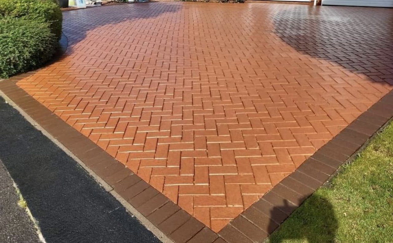 Same herringbone driveway after cleaning, bright red and clean