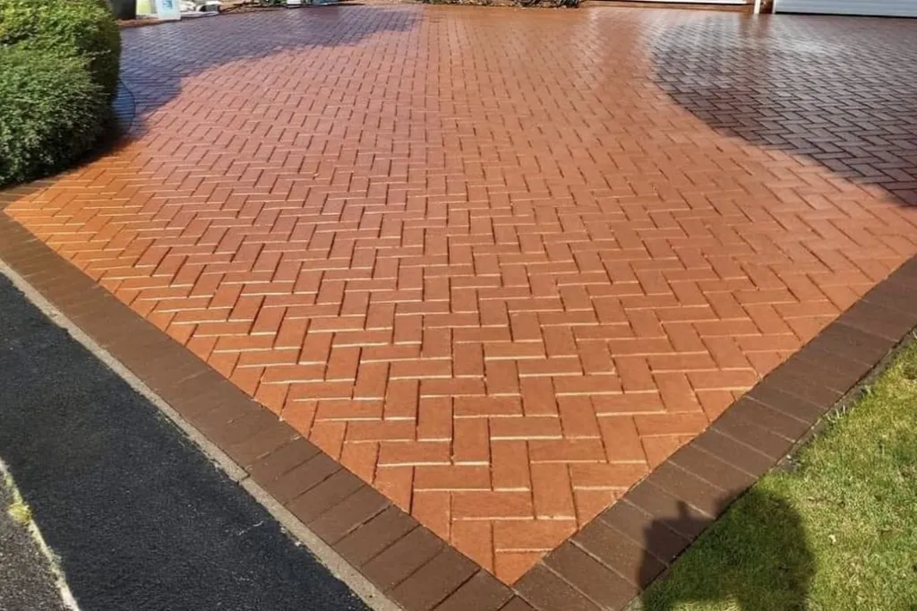 Same herringbone driveway after cleaning, bright red and clean