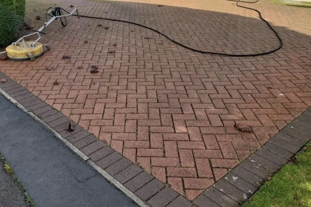Herringbone block paving driveway before cleaning